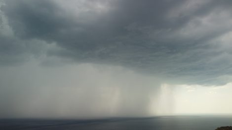 aerial view footage of rain clouds over sea ocean black clouds in bad weather day over sea surface